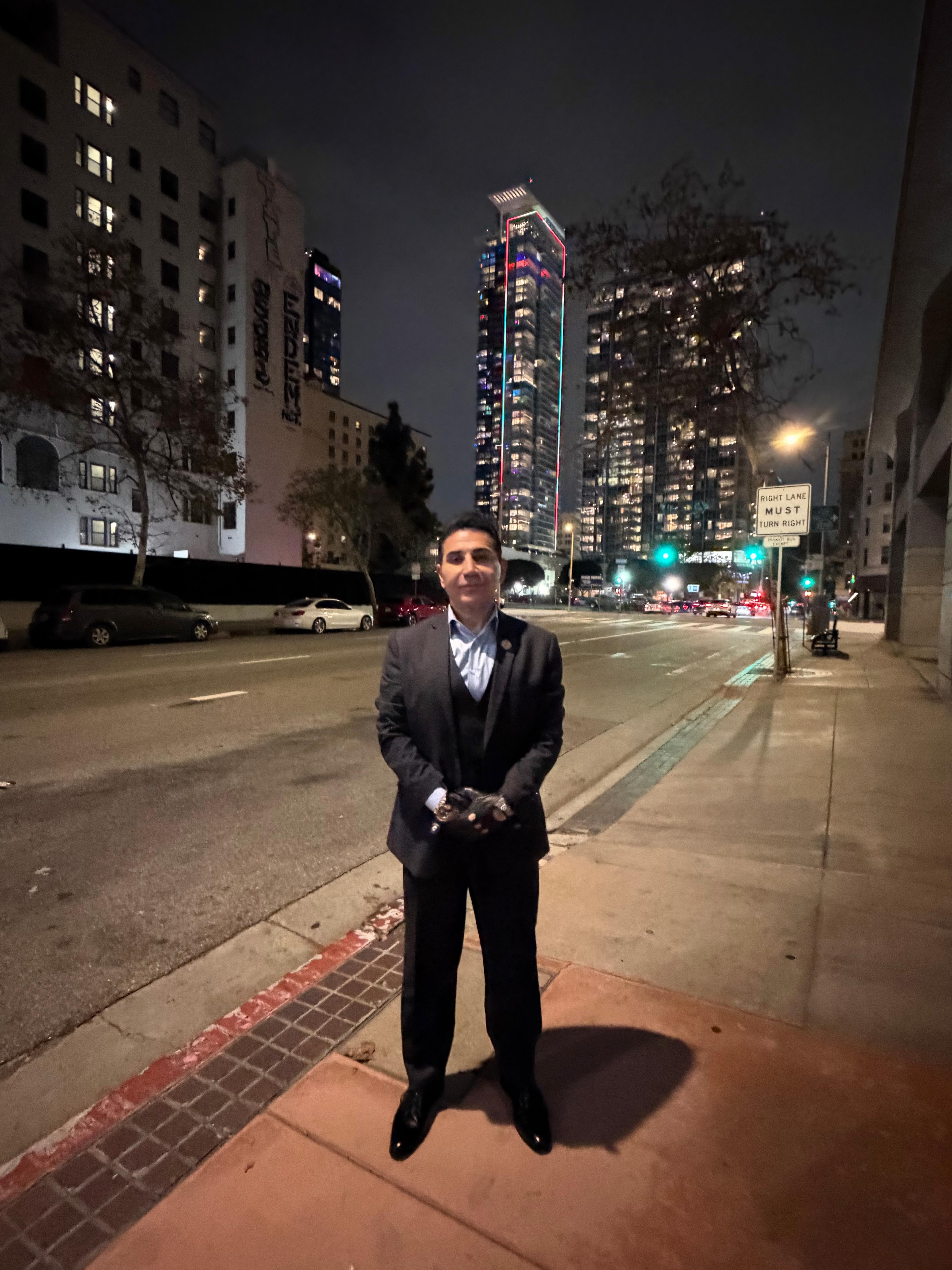 Fereidoun Khalilian full-length night portrait with city skyline