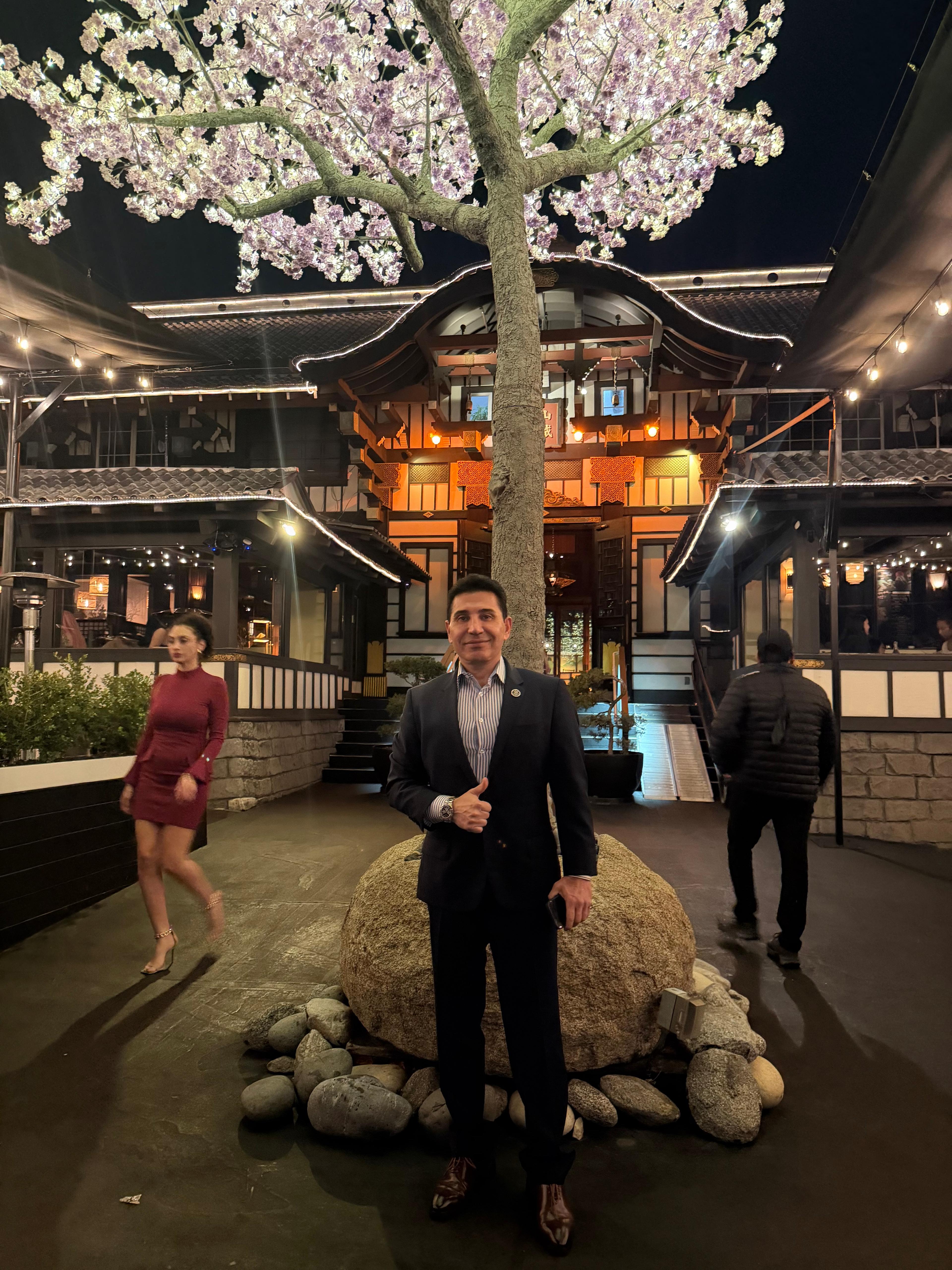 Fred Khalilian at Japanese garden restaurant night with cherry blossom tree